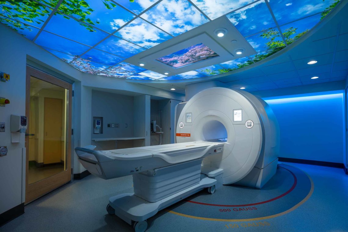 Caring MR Suite® Radiology Solutions featuring 65" 4K Ceiling Video Display embedded in LED Illuminated Image Ceiling. Video Display for MRI and Healthcare